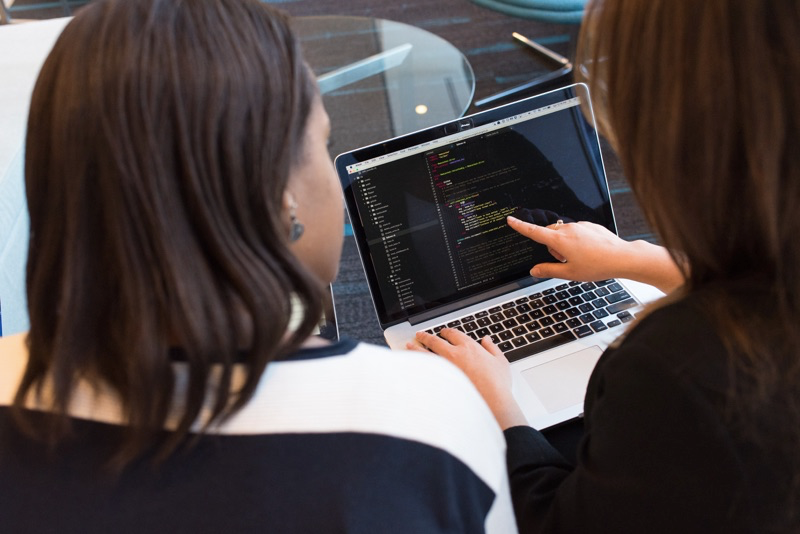 2 front-end developers pointing at laptop screen