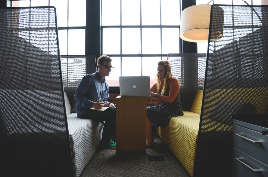 man and woman meeting in a booth