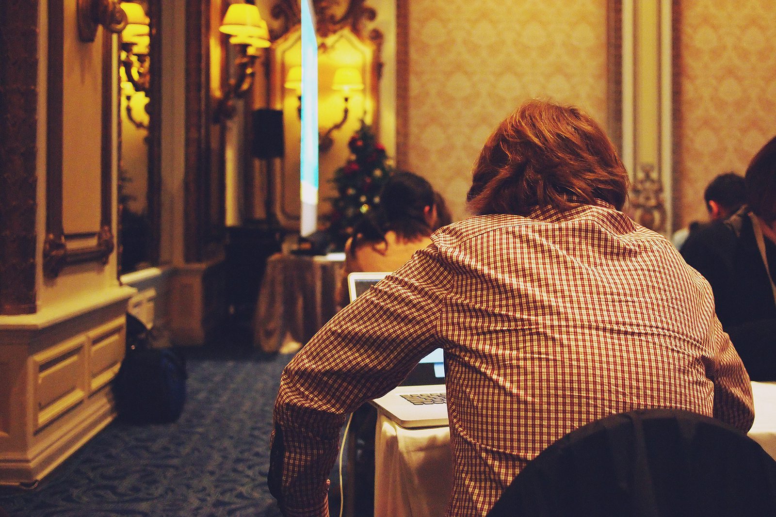 Man looking at his laptop at a networking event 