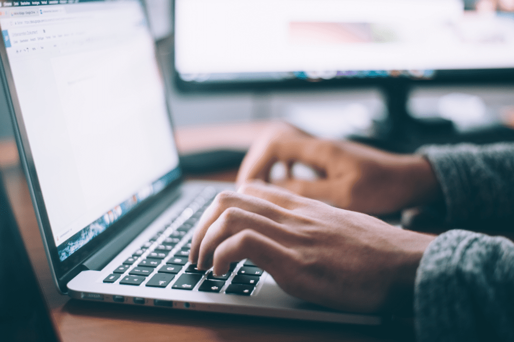 Hands working on a laptop