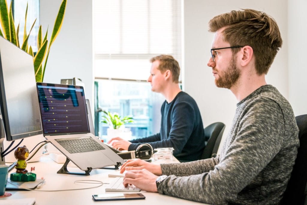 Person on laptop using docker at desk