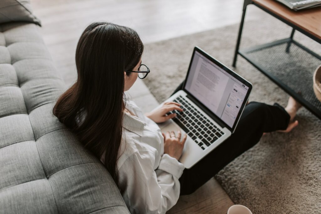 woman with glasses working at home