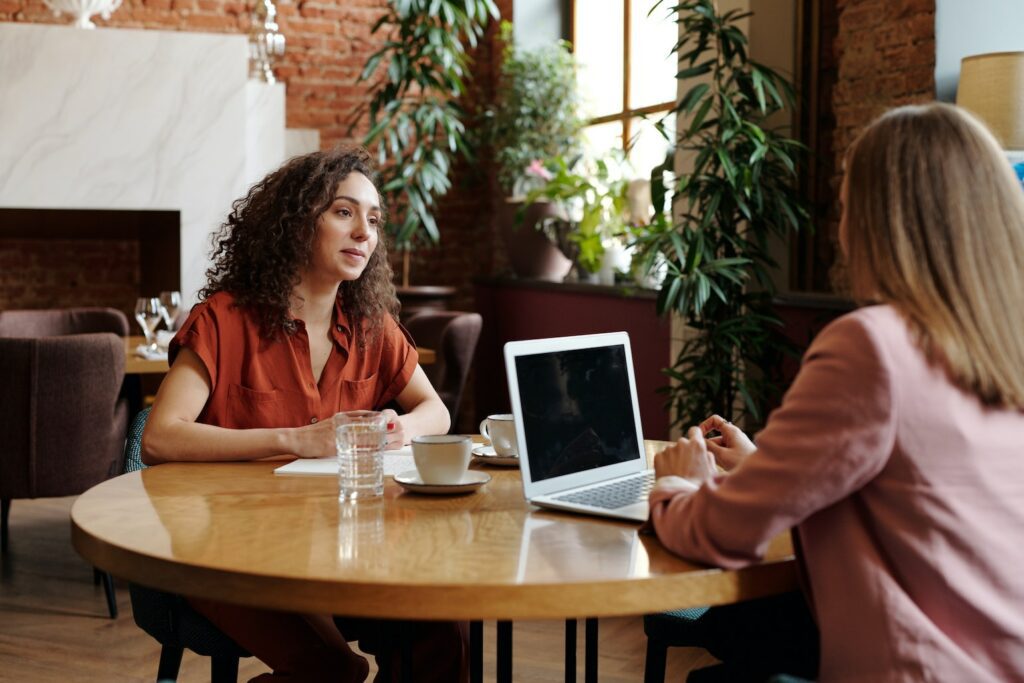 two women talking over coffee