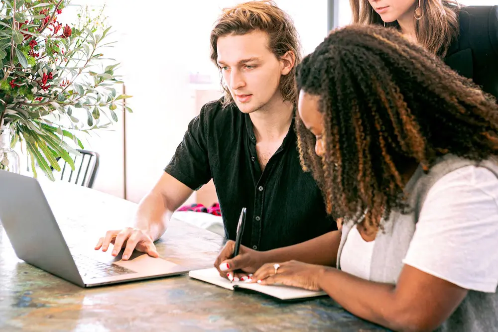 Man working at laptop with woman