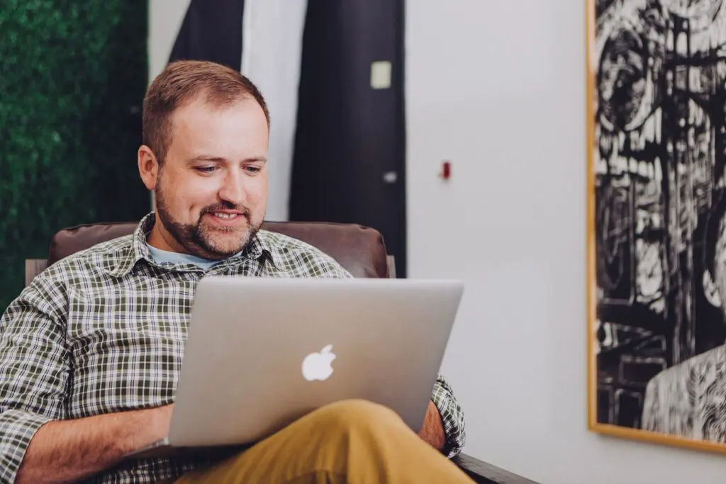 man typing on laptop