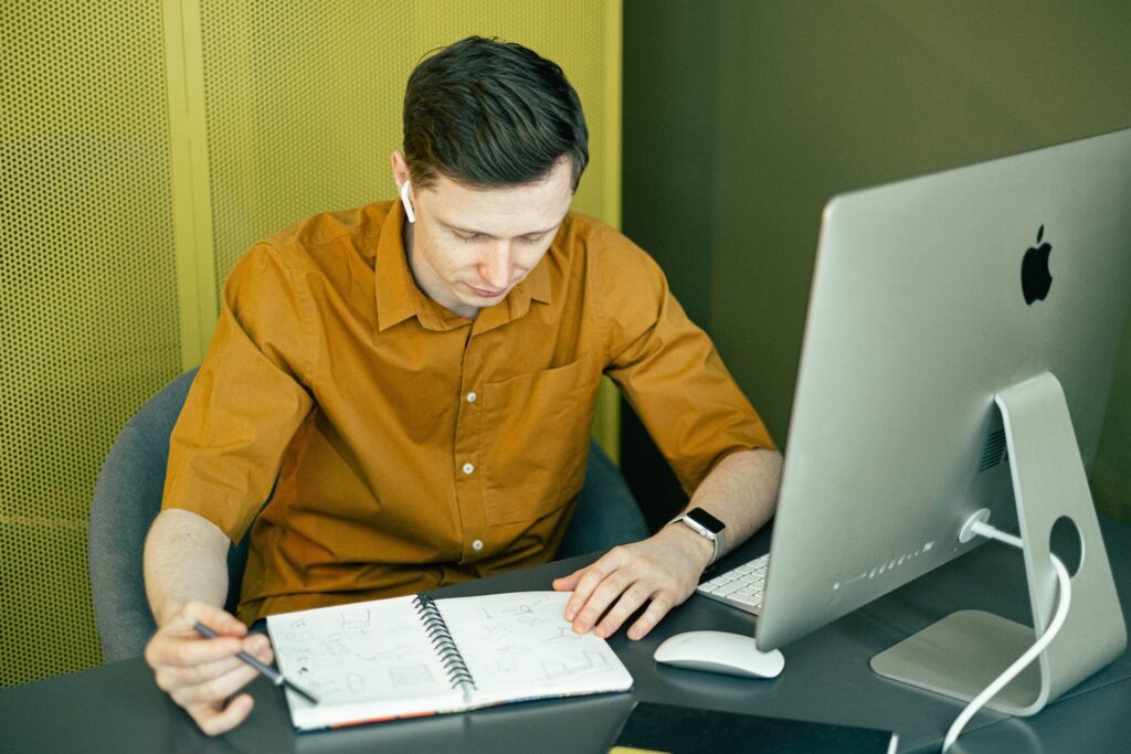 man practicing on notebook