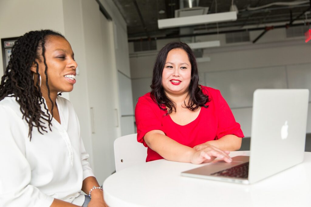 Woman assisting a colleague with IT