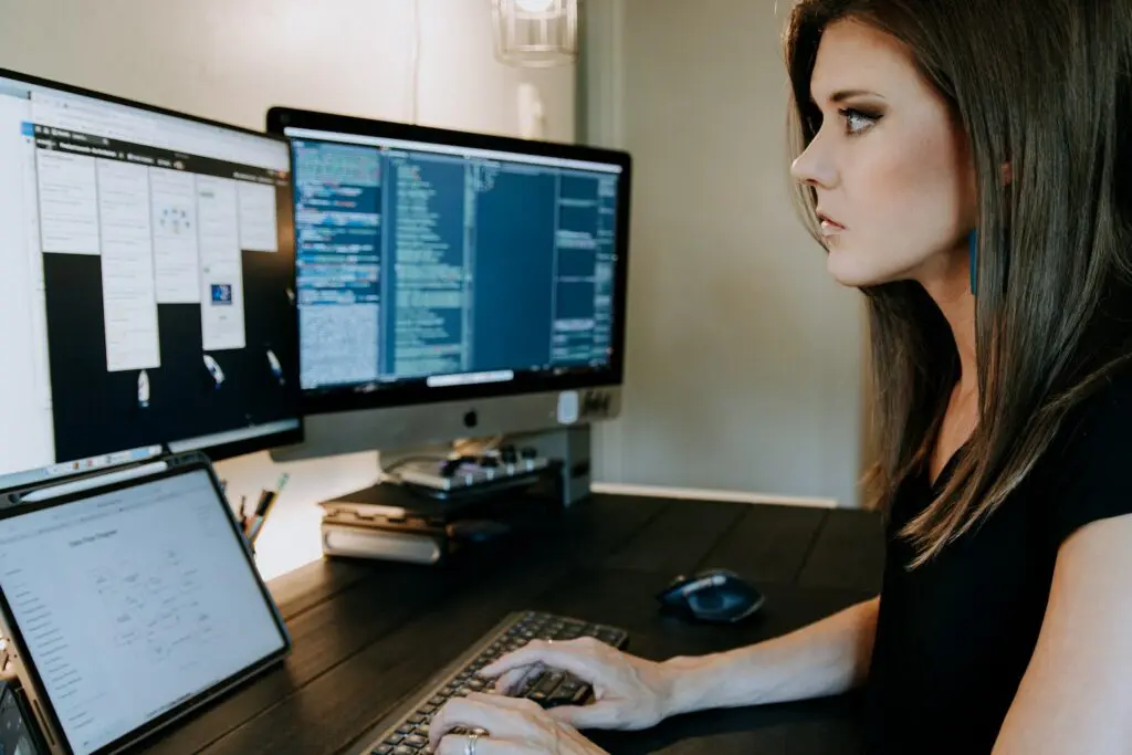 woman working on multiple screens